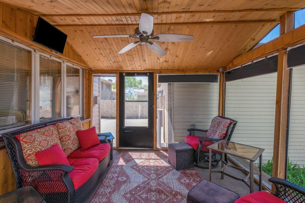 Screen Porch has floor to ceiling Shades & Ceiling fan