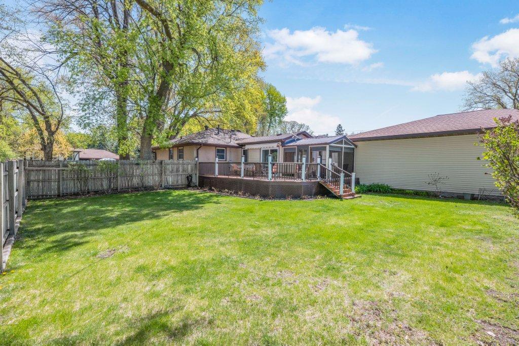 Huge Private Back Yard surrounded by perennial flowers and bushes