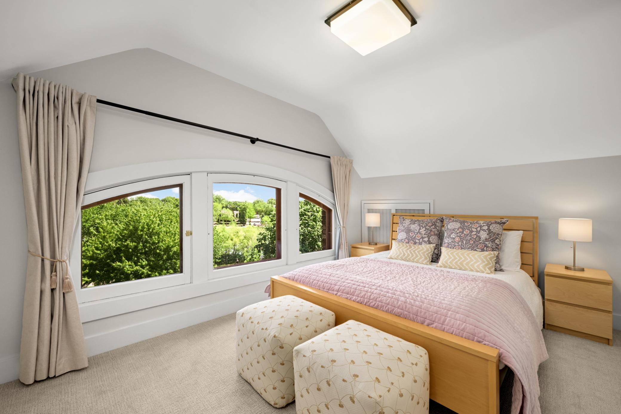 Third floor bedroom with a bird's eye view of Lake of the Isles. The perfect guest retreat.