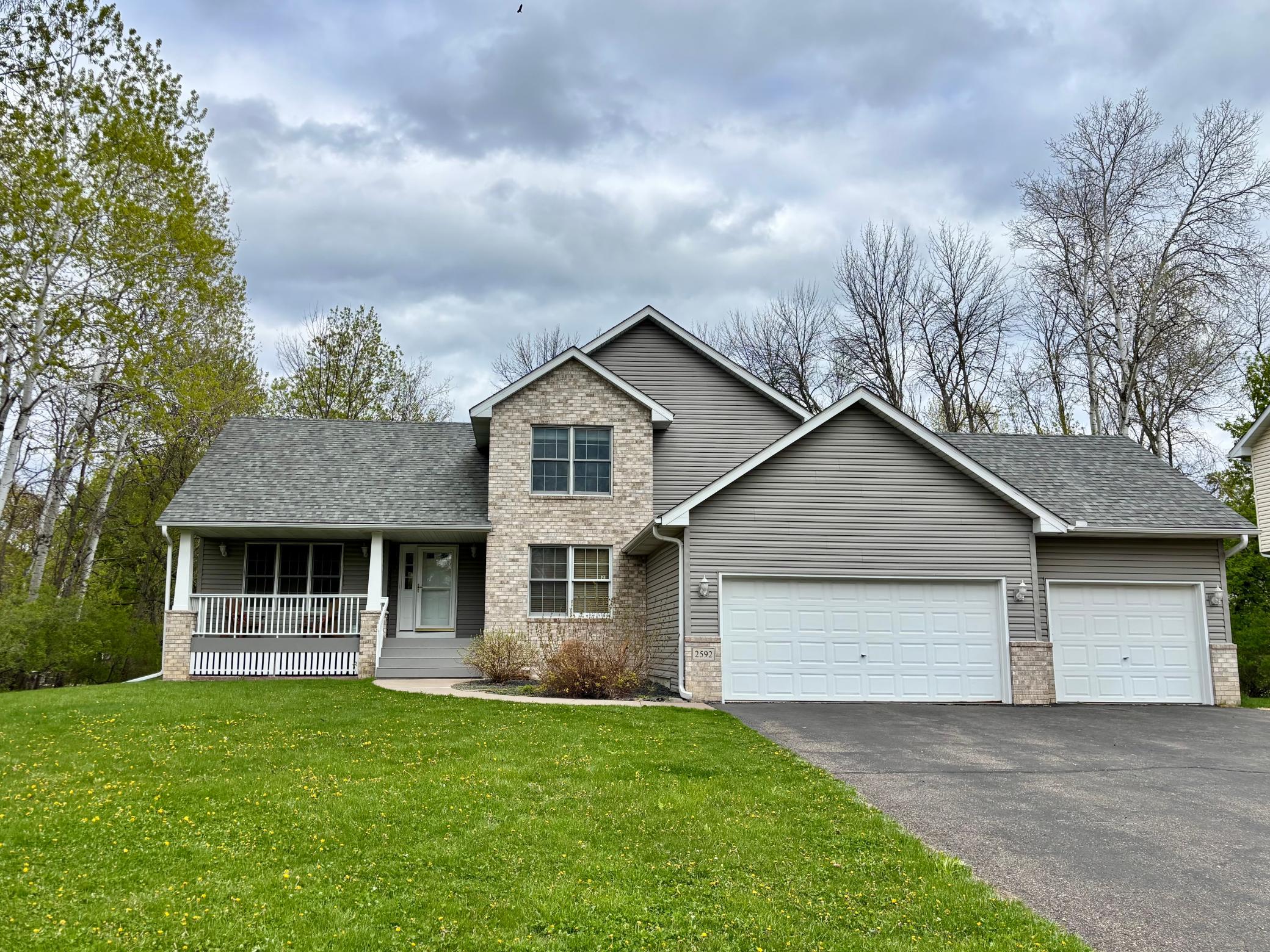 2-story walkout home nestled on a private half-acre cul-de-sac lot overlooking a serene pond and wooded backdrop.