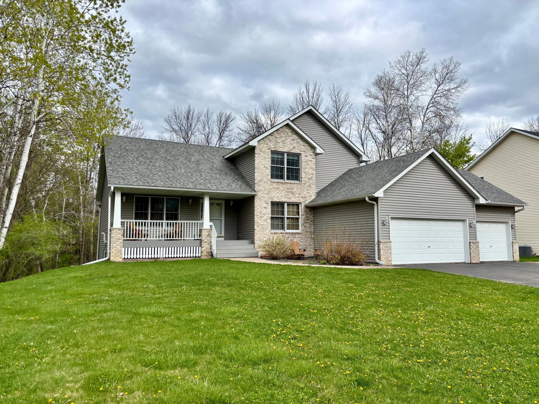 2-story walkout home nestled on a private half-acre cul-de-sac lot overlooking a serene pond and wooded backdrop.