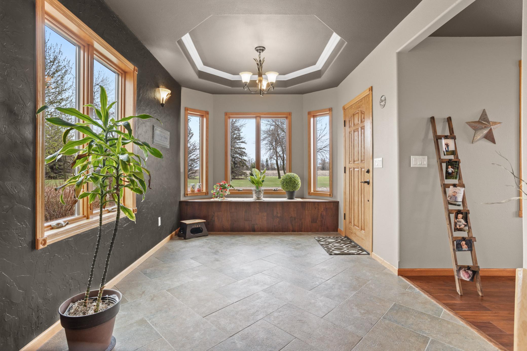 Foyer with Trayed Ceilings and Bay Windows