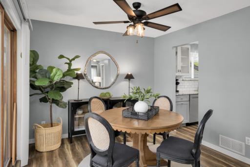 Natural light flows into the space from the sliding glass doors. The open layout connects seamlessly to the updated kitchen, making the space ideal for both casual meals and entertaining guests.
