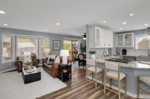 This beautifully updated open-concept living space combines modern style with warmth and functionality. The spacious main level features luxury wood-look flooring, soft gray walls, crisp white trim and abundant recessed lighting