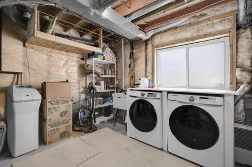 Storage room in the lower level with front load washer/dryer that will stay with the home for the new buyers to enjoy