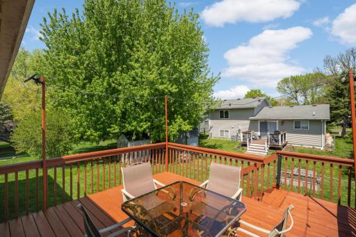 This spacious backyard deck offers the perfect setting for relaxing, entertaining, and enjoying the outdoors. The elevated wood deck features warm-toned decking, sturdy railings, and cafÃ©-style string lighting. Bonus, nice big shed for extra storage