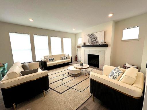 Wall of oversized windows in the living room, with views of nature in the back yard.