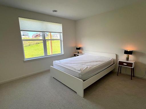 Fourth bedroom downstairs with views of the backyard.