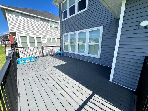 Spacious maintenance-free deck overlooking the backyard, perfect for relaxing or entertaining.