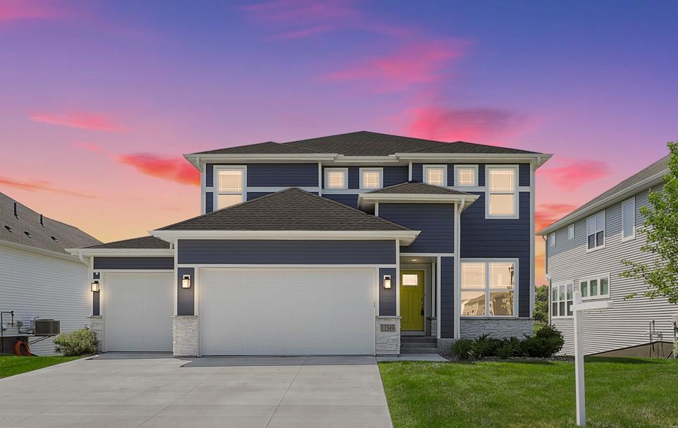Stunning two-story home showcasing modern curb appeal, a warm welcoming entry, and an expansive three-car garage-AI Enhanced