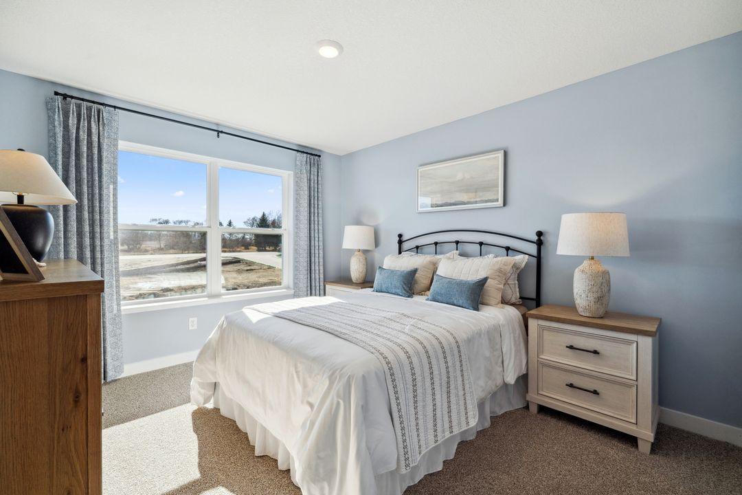 One of the 3 additional rooms on upper level with a walk in closet.