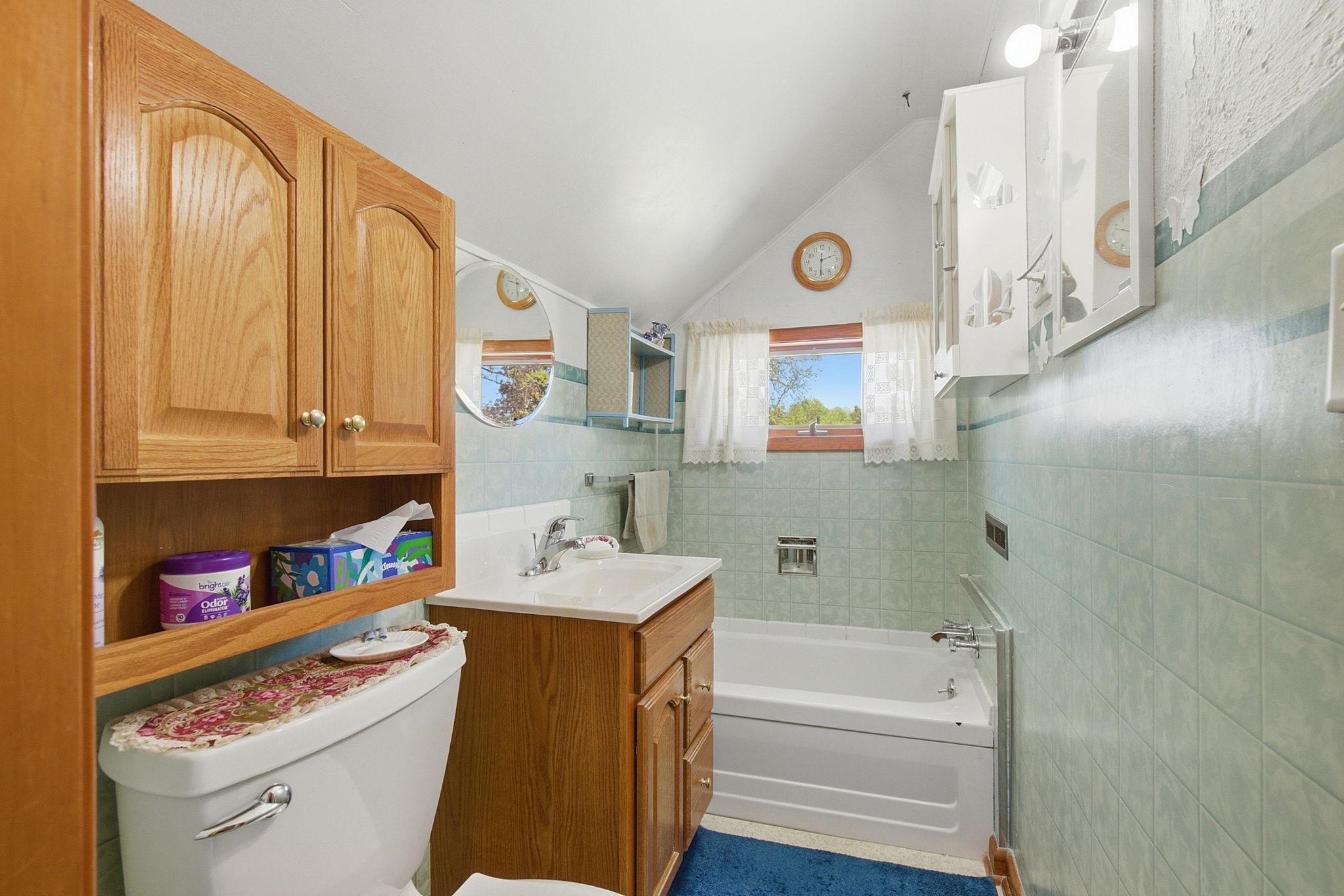 Bathroom has newer vanity & storage cabinet.