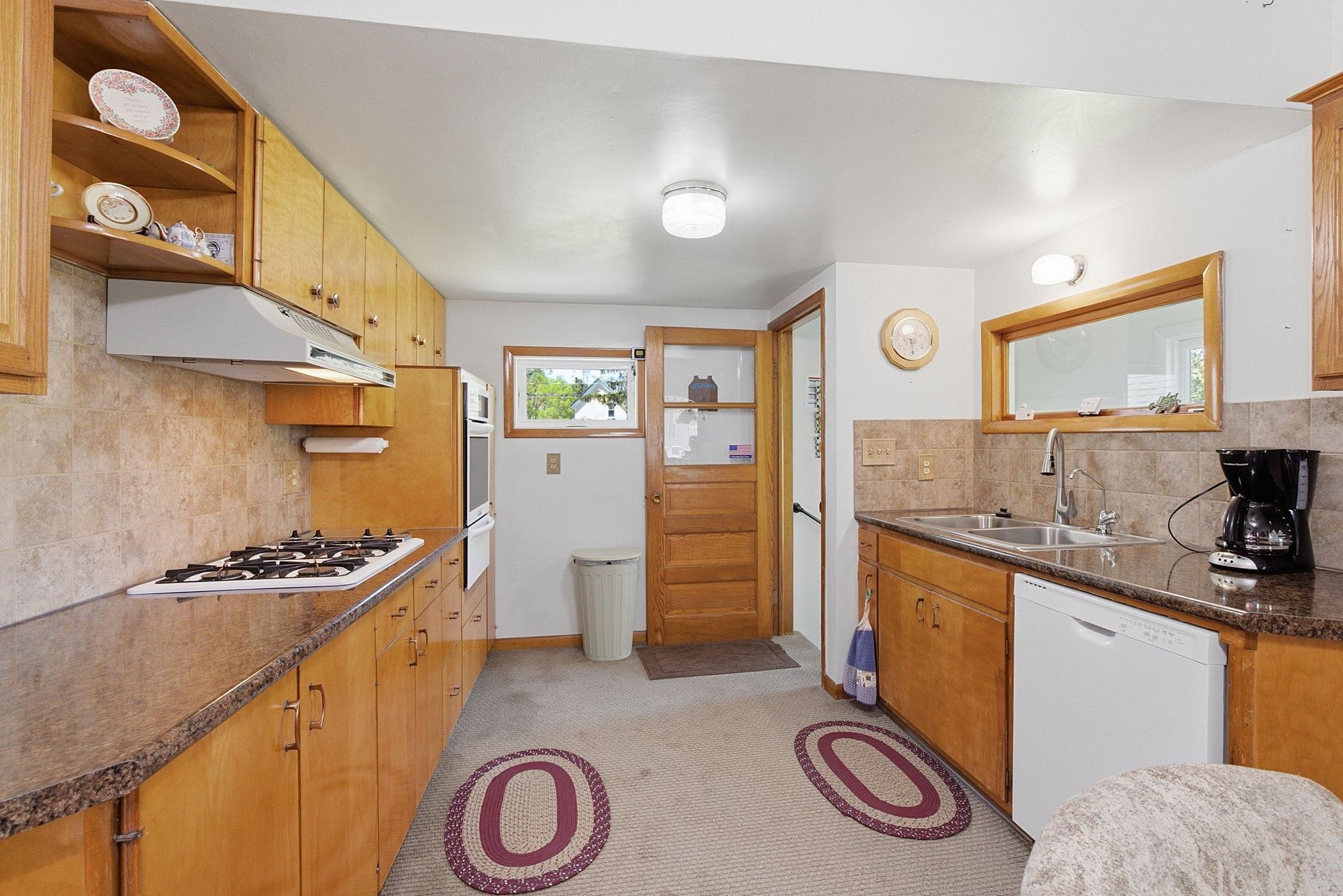 New dishwasher and convenient built-in wall over and newer countertops & backsplash.