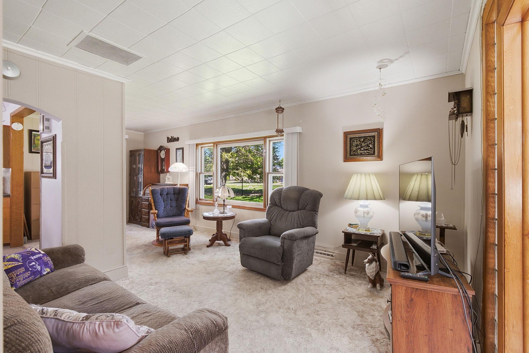 Huge bright picture window in living area and beautiful hardwoods underneath the carpet.