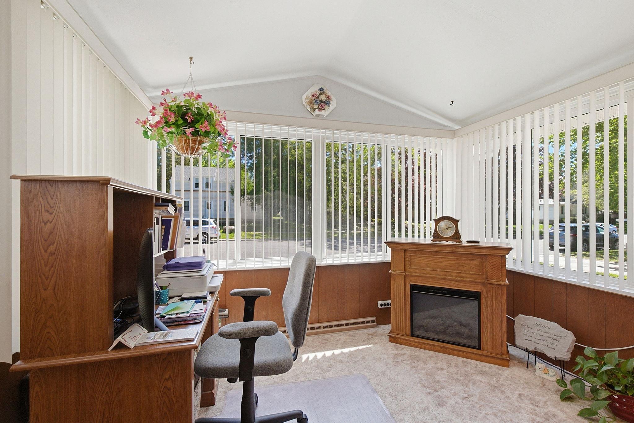 Welcoming front sun room with fireplace that stays with the home.