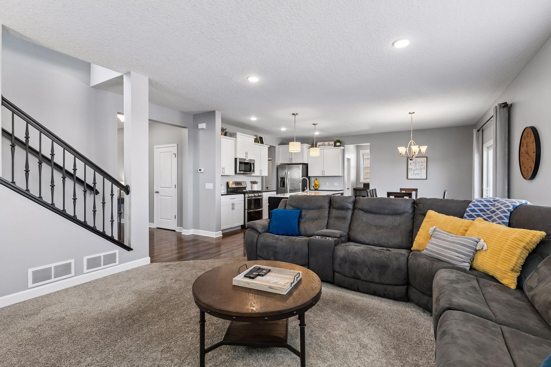 The bright, open floor plan flows effortlessly into the living and dining areas, highlighted by a beautiful kitchen with a large center island, walk-in pantry, and a flexible space perfect for a coffee bar or extra office space.