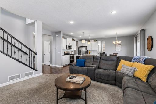 The bright, open floor plan flows effortlessly into the living and dining areas, highlighted by a beautiful kitchen with a large center island, walk-in pantry, and a flexible space perfect for a coffee bar or extra office space.