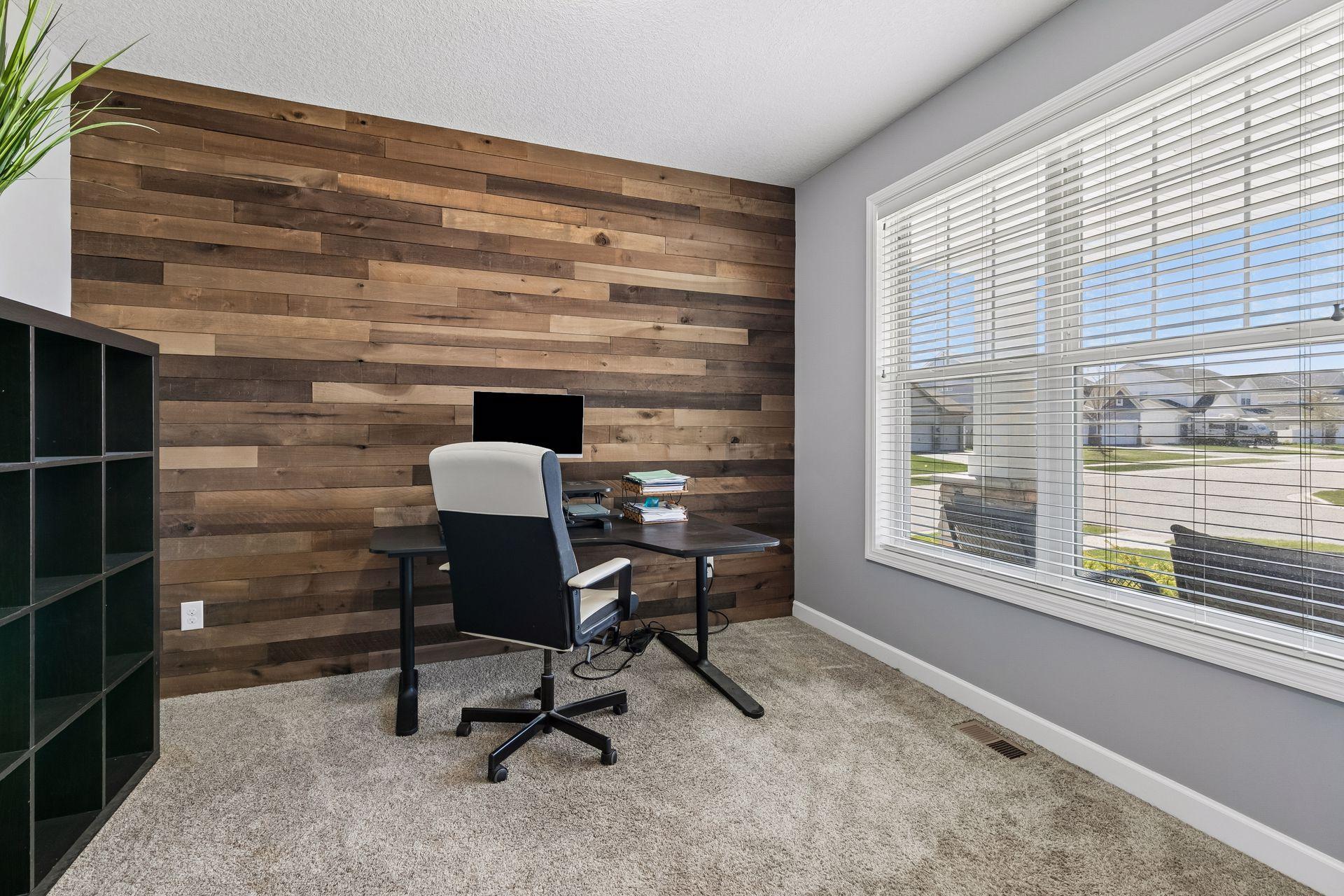 The versatile main-floor front room can be used as a dedicated home office, a formal dining room, or a sitting area.
