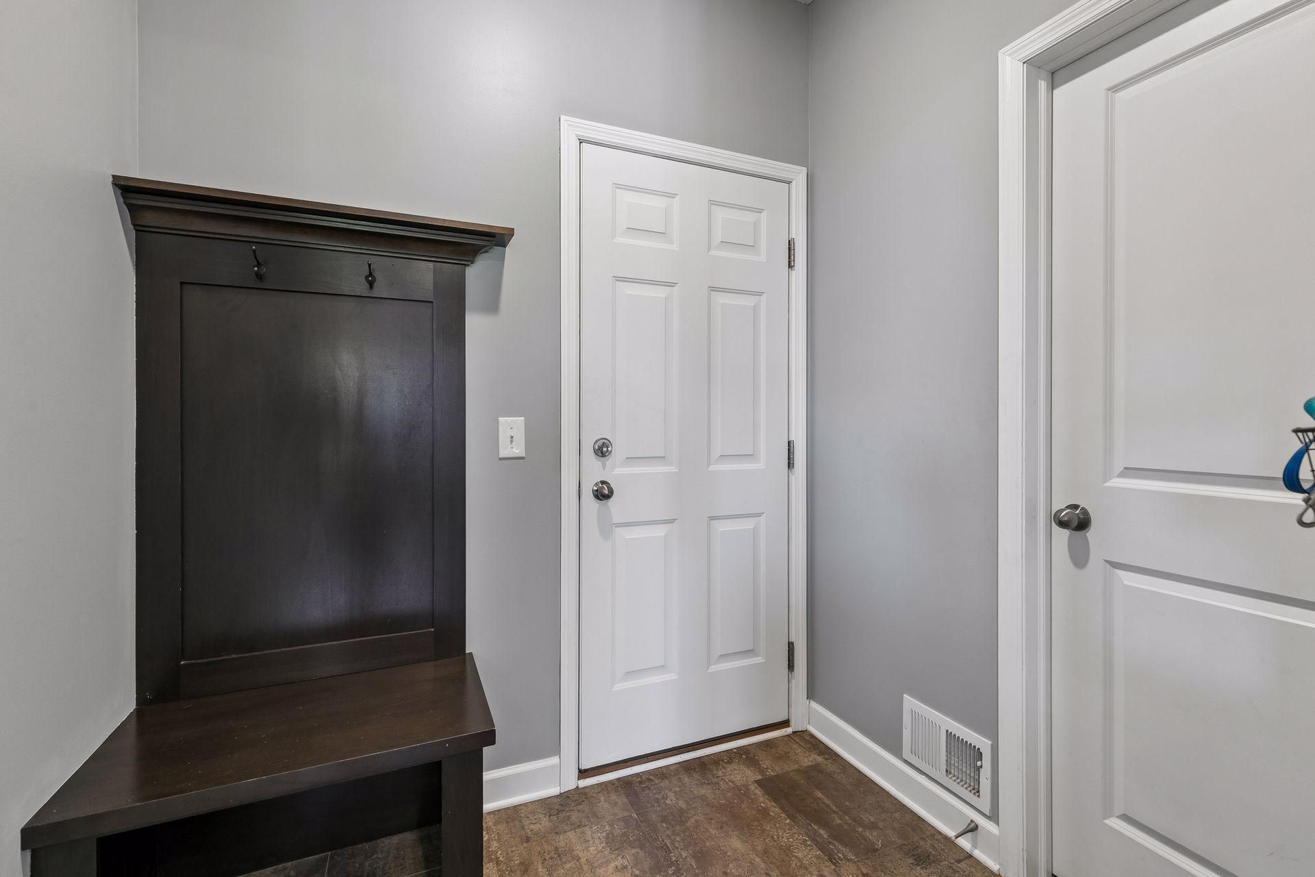 Mudroom located by half bathroom and three car garage.