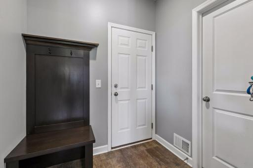 Mudroom located by half bathroom and three car garage.