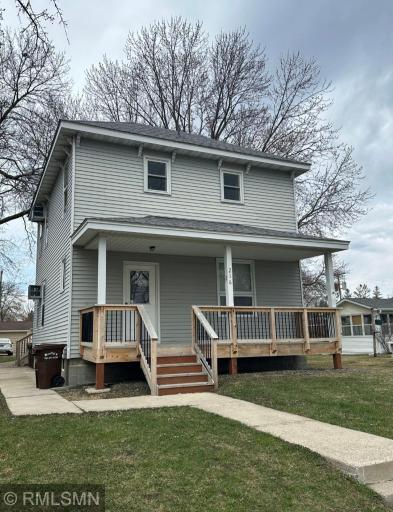 Front of duplex from the street with large front porch