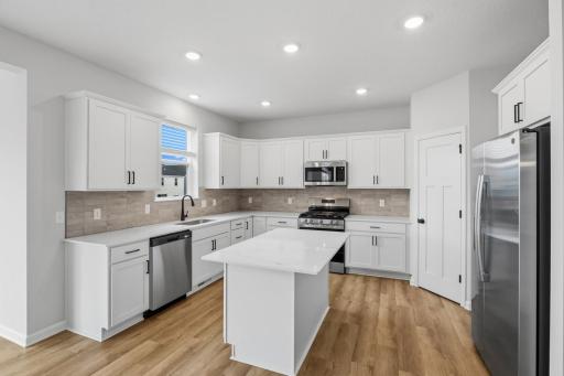The heart of the home! Quartz countertops, corner pantry, and stainless steel GE appliances are included with the home. So much to love!