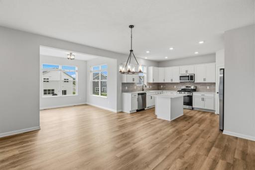 Open concept kitchen, dining, and family room with 9' ceilings make the space feel bright and open.