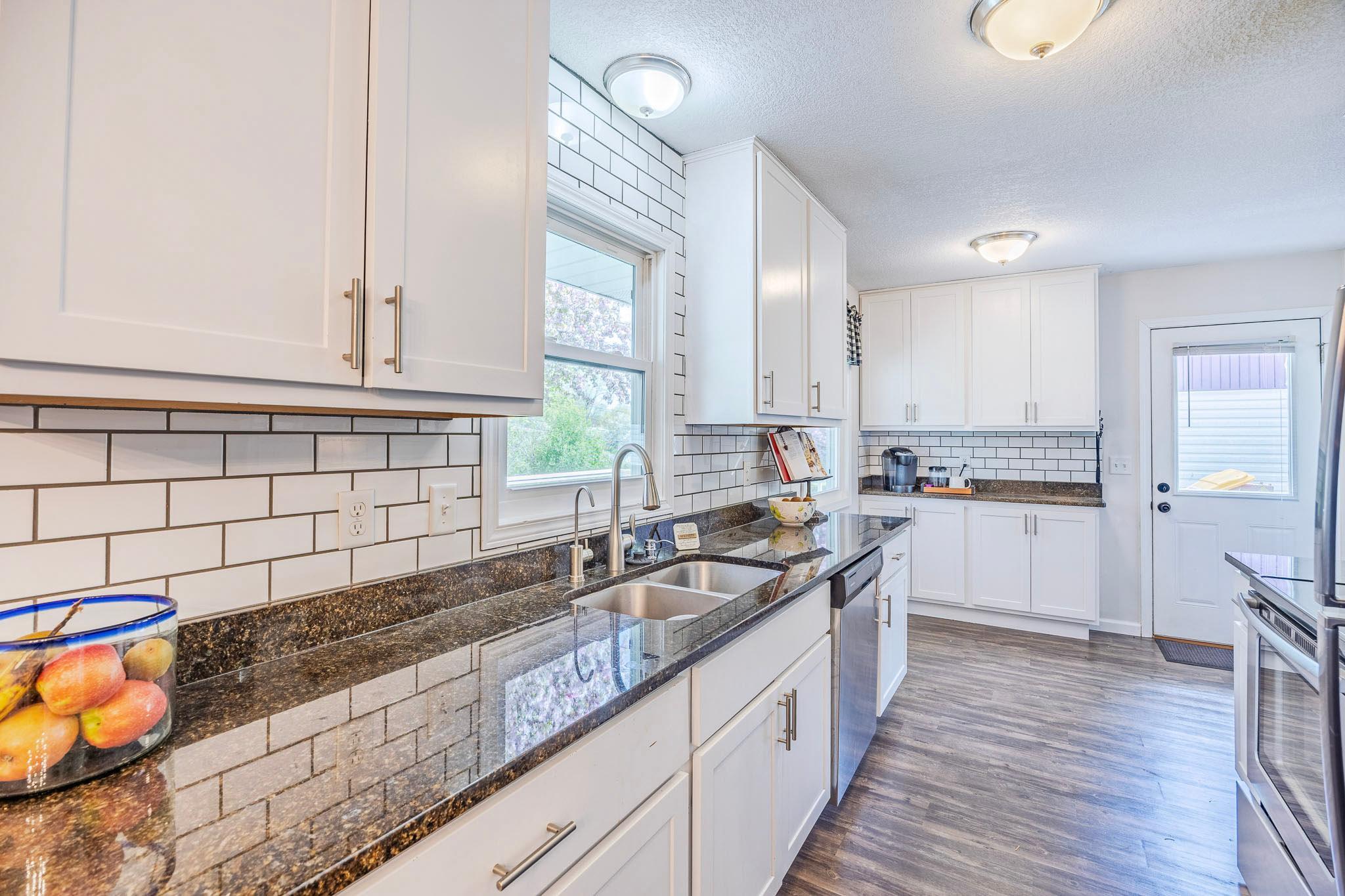 Galley Kitchen with Granite Counter tops and Subway Tile backsplash!