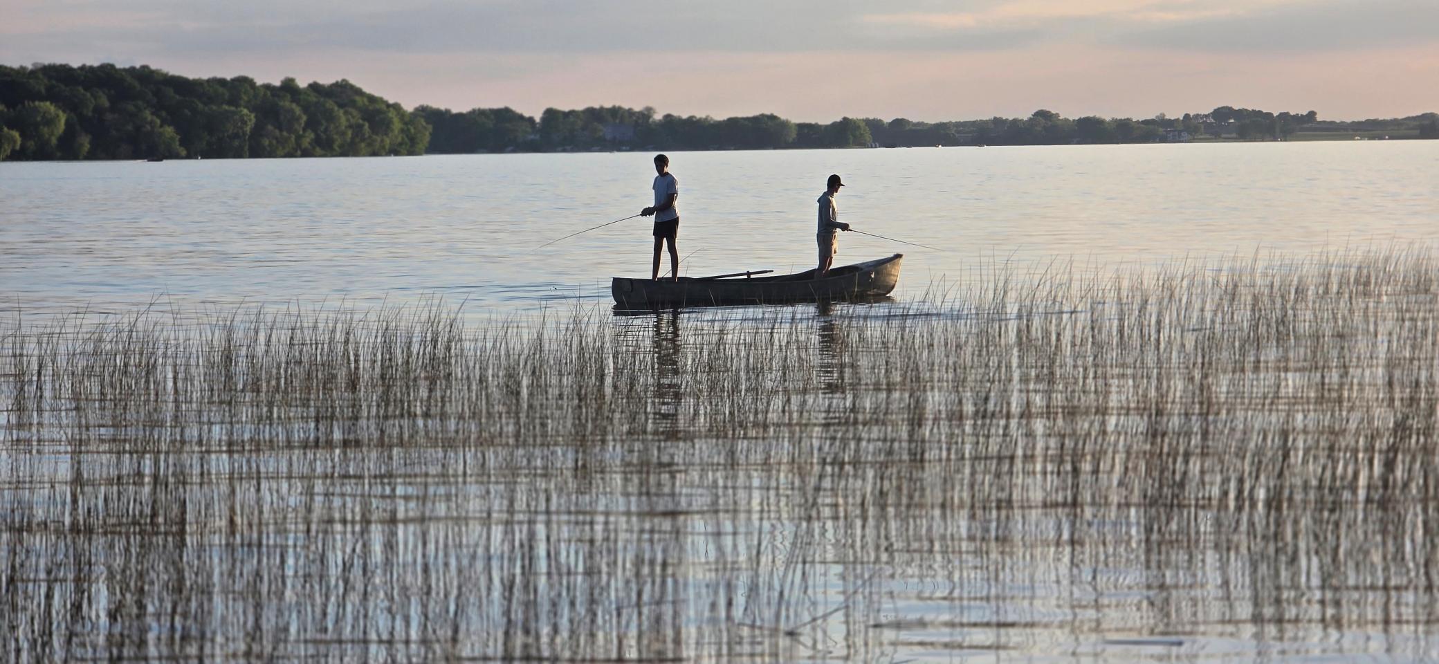 Photo of family members fishing near the shoreline. Many fish stories are waiting to be told.