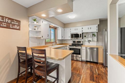 The stainless-steel appliances sparkle with all of the natural sunlight shining in.