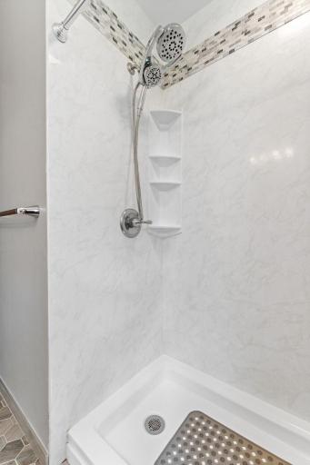 Separate shower with update tile and surround in the original bathroom.