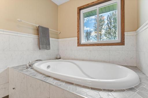 The previous owner changed a main floor bedroom into extra space for the bathroom including a soaking tub, sink and vanity and additional closet space.