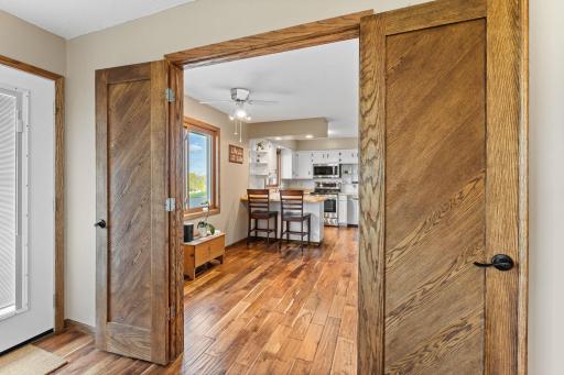 Beautiful wooden French doors separating the kitchen and living room compliment the acacia floors.