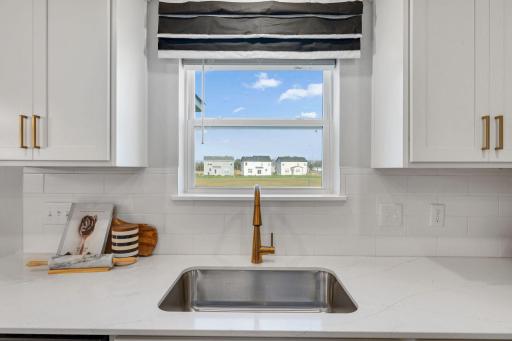 Silestone quartz countertops in the kitchen are non-porous, bacteria resistant and low maintenance, with no sealing required! Sink overlooks your backyard.