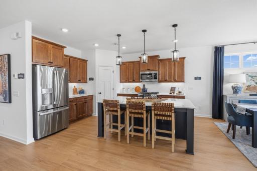 Kitchen features huge island, quartz countertope and backsplash, sweet gas range!