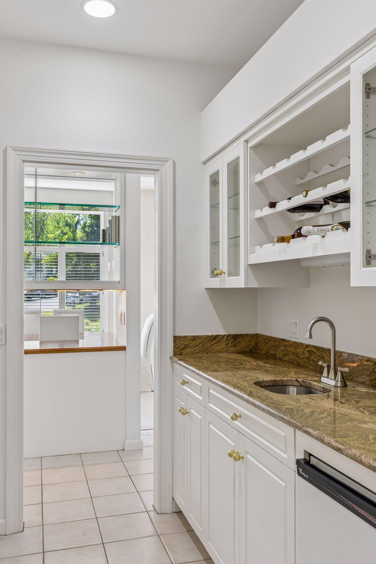 Butler's pantry with fridge and wet bar.