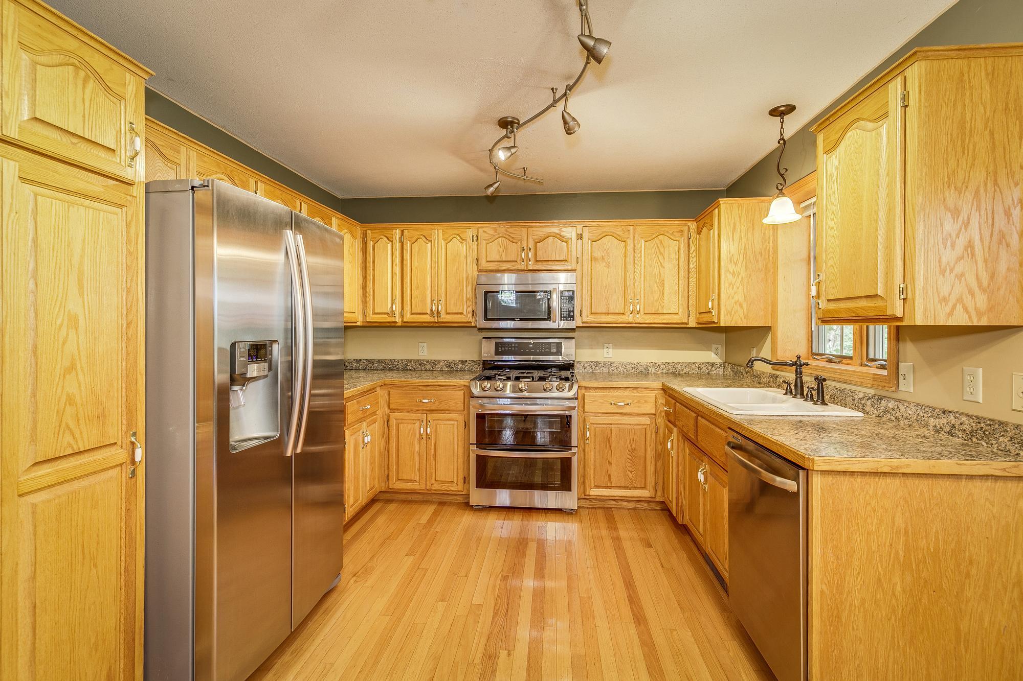 Updated Kitchen with Stainless Appliances featuring a New Range with Double Oven & New Kitchen Faucet.
