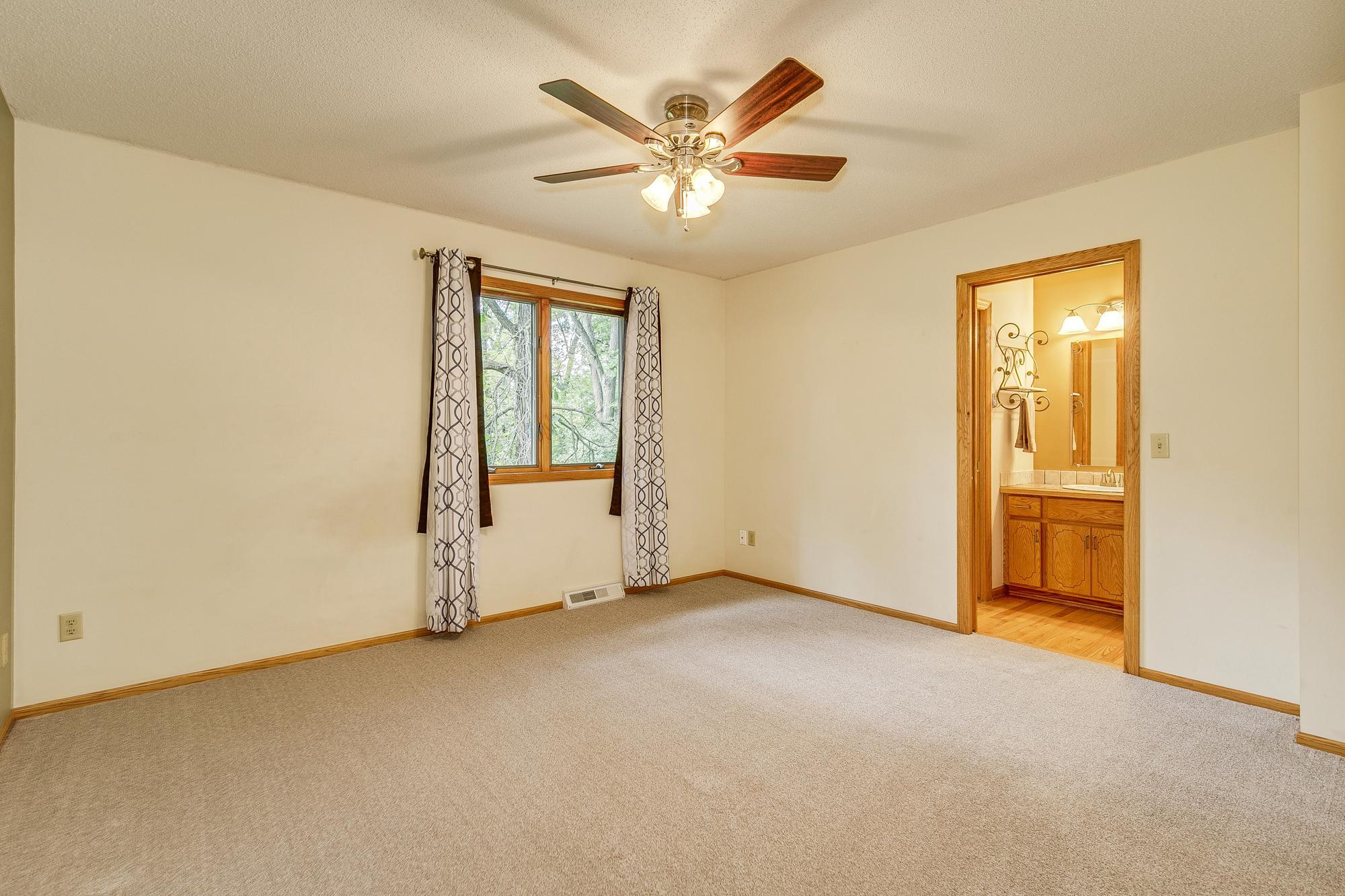 Master Bedroom with Updated Full Bath, walk in closet, New Carpet and New Ceiling Fan.