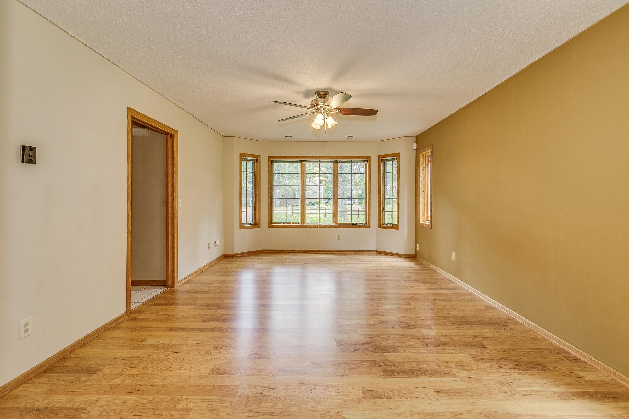 Main Level Family Room with New Pergo Flooring and Ceiling Fan. All windows throughout the home are Anderson windows.