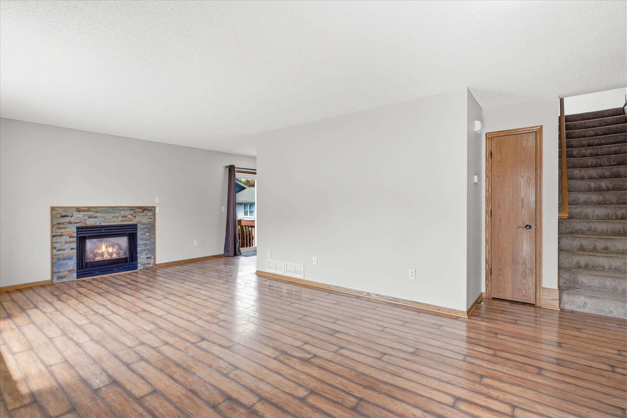 Spacious living room with durable wood flooring, neutral paint tones, and an open layout perfect for everyday living and entertaining.