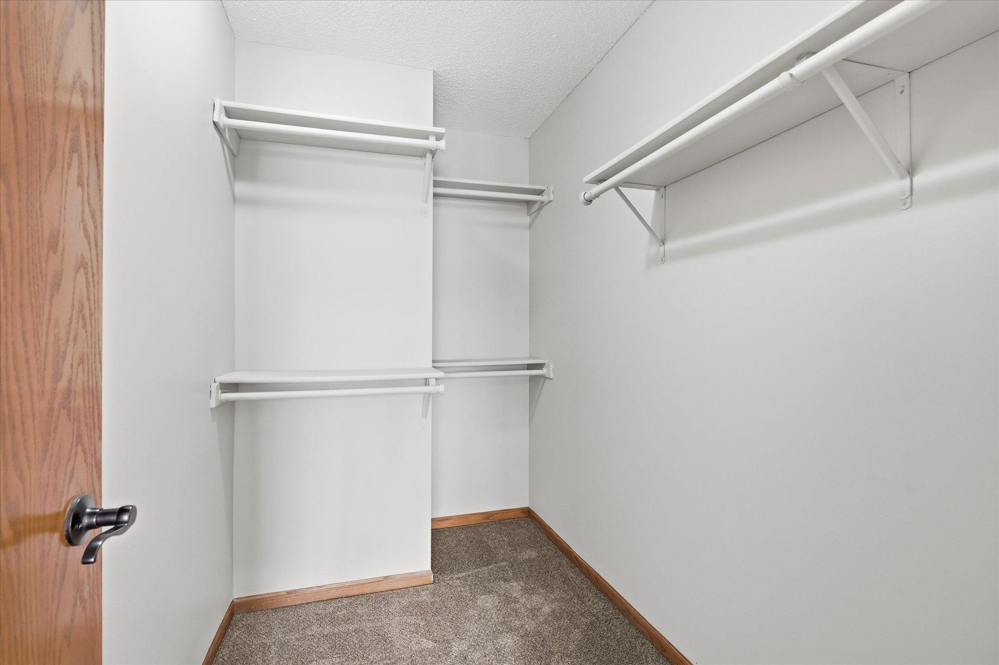 Generous walk-in closet provides excellent storage and organization space.