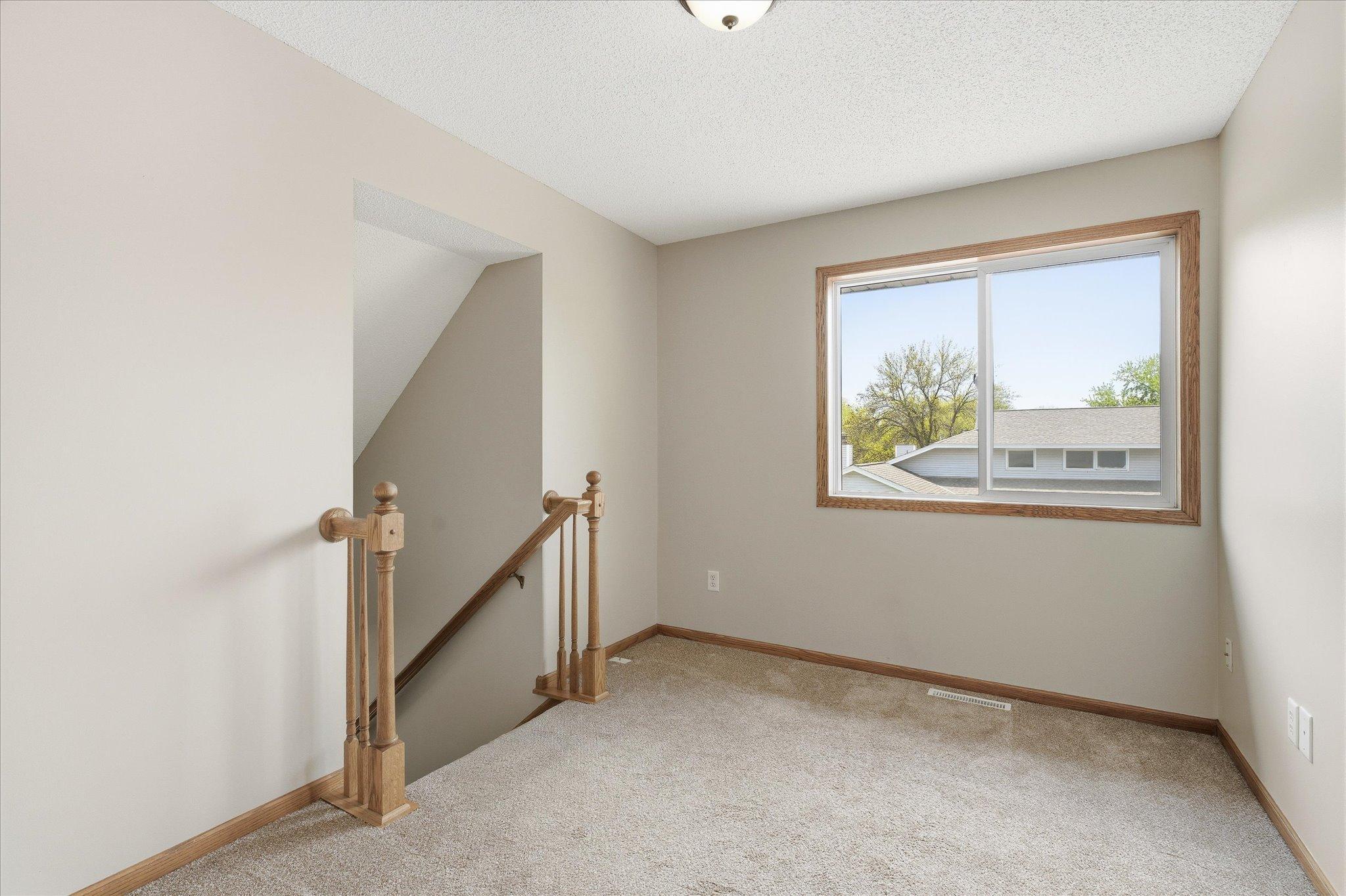 Versatile upper-level loft area offers the perfect space for a home office, reading nook, or additional lounge area.