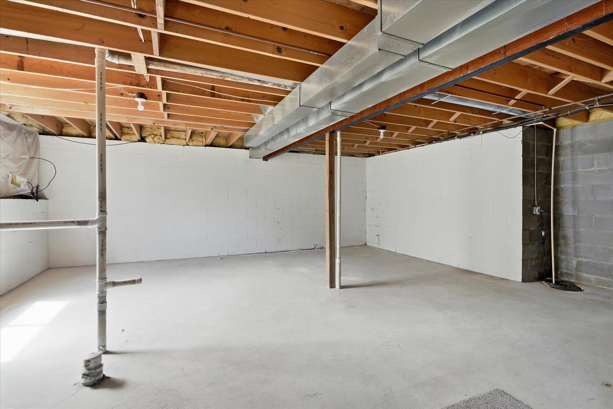 Huge unfinished lower level includes a convenient bathroom rough-in for future expansion.
