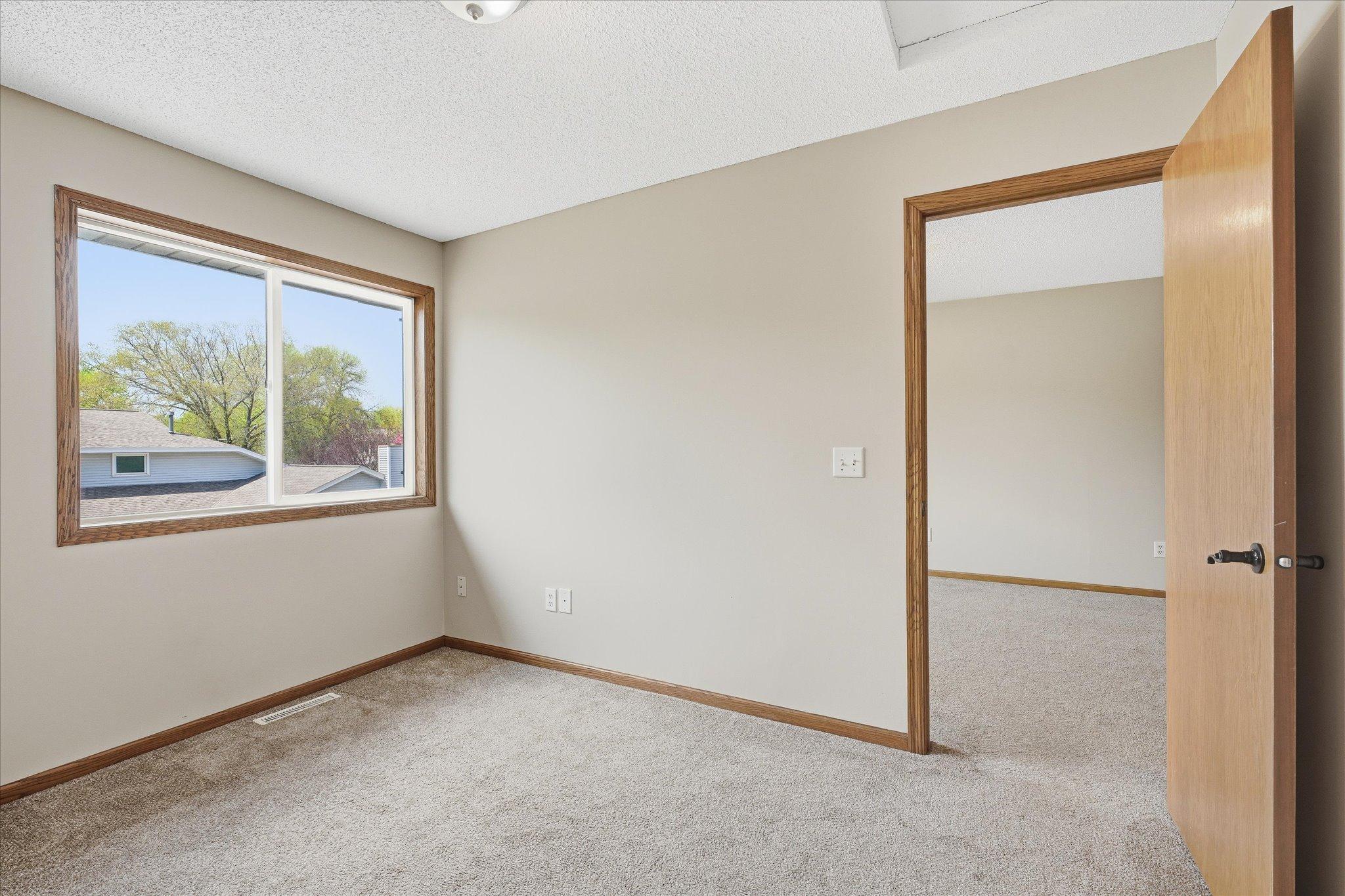 Bright loft space overlooking the staircase with large window bringing in great natural light.