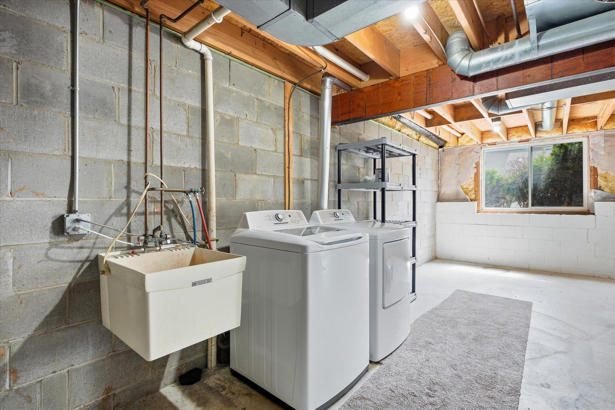Dedicated laundry and utility area with plenty of additional room for storage and organization.