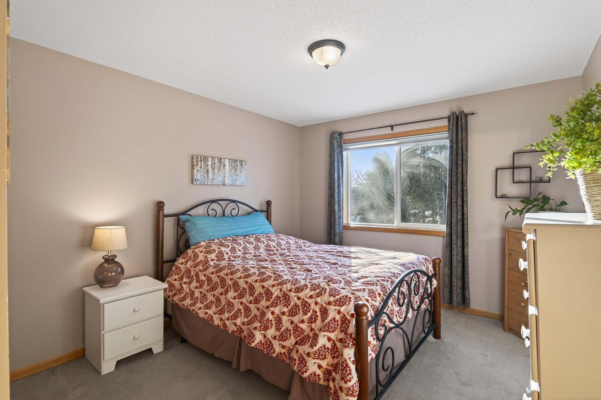 Primary bedroom with walk in closet and full ensuite bathroom