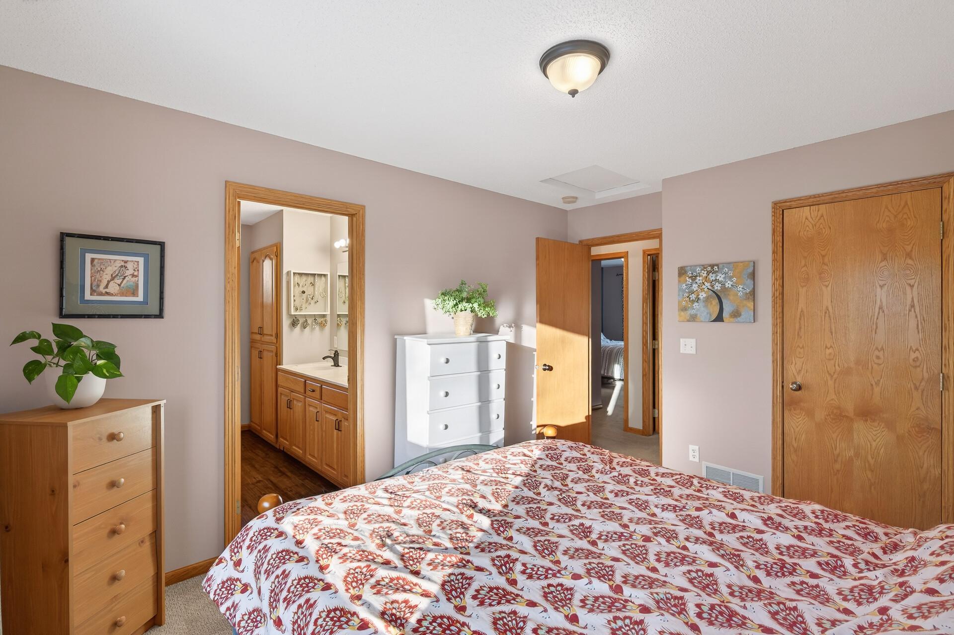 Primary bedroom with walk in closet and full ensuite bathroom