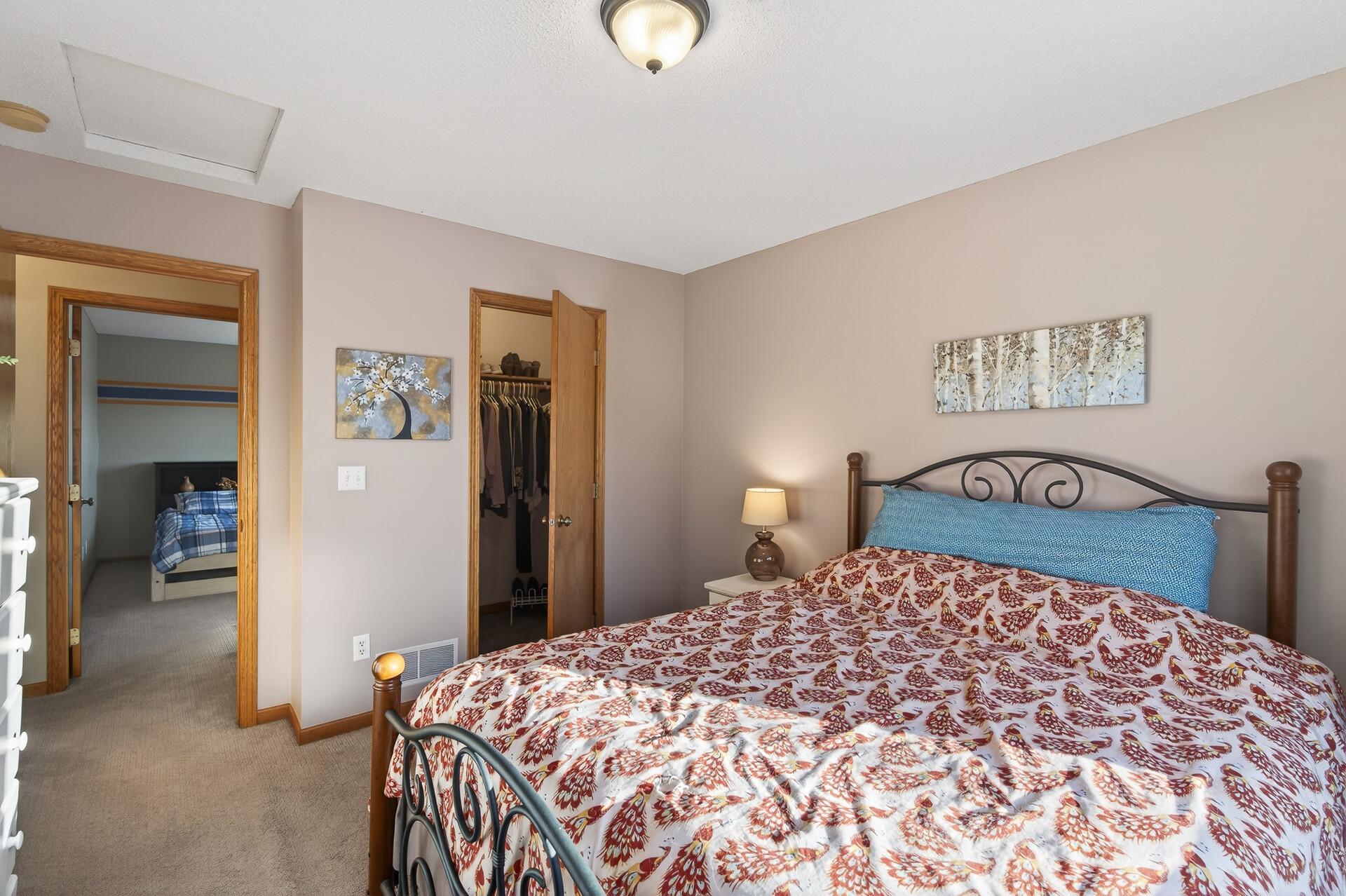 Primary bedroom with walk in closet and full ensuite bathroom