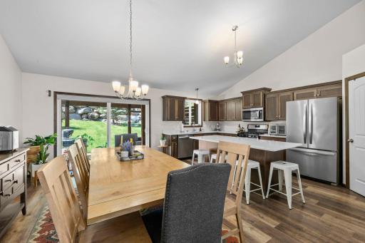 View of the dining area, eat-in kitchen and walkout to the fenced backyard