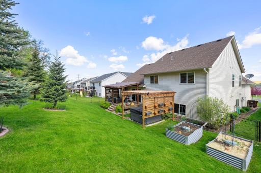 Raised garden beds and a fenced yard for pets and kids to play